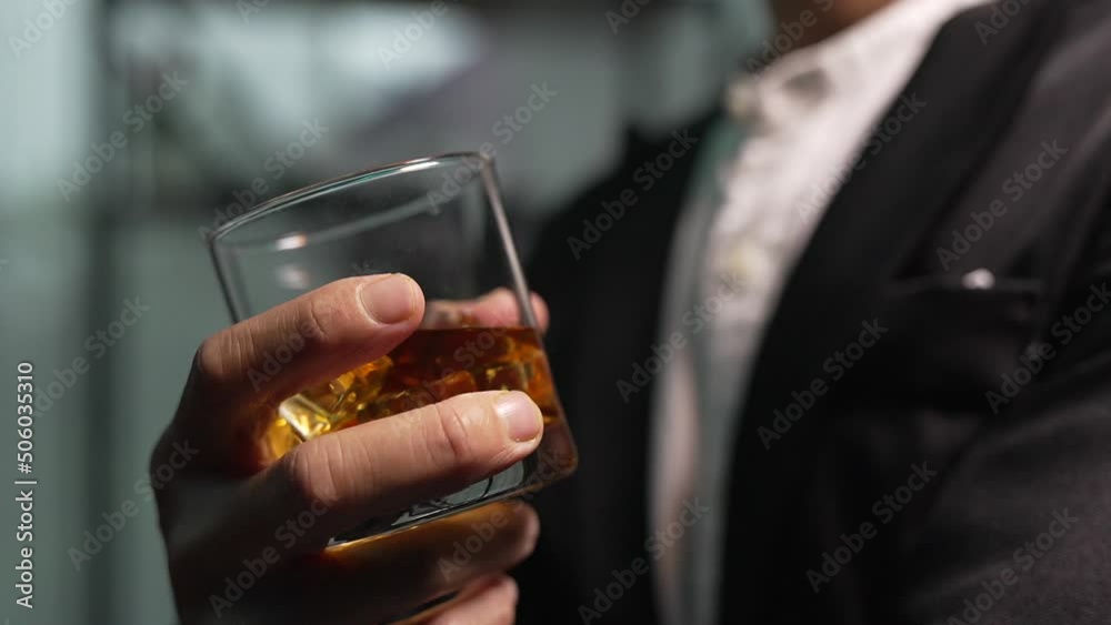 businessman holding whiskey, a restaurant businessman holding whiskey, a restaurant