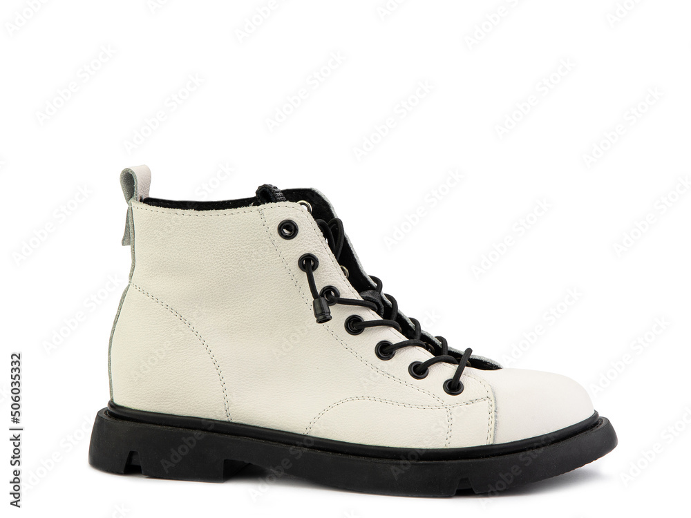 White leather ankle boots with black laces and black rubber sole. Isolated close-up on white background. Right side view. Casual seasonal shoes.