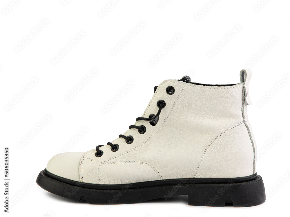 White leather ankle boots with black laces and black rubber sole. Isolated close-up on white background. Left side view. Casual seasonal shoes. White leather ankle boots with black laces and black rubber sole. Isolated close-up on white background. Left side view. Casual seasonal shoes.