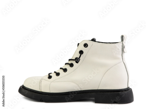 White leather ankle boots with black laces and black rubber sole. Isolated close-up on white background. Left side view. Casual seasonal shoes.