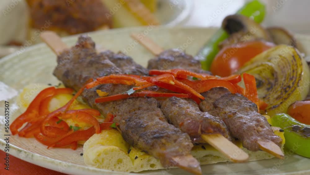 Turkish kebab serving plate.
Turkish adana kebab on a serving plate.
Turkish kebab serving plate.
Turkish adana kebab on a serving plate.