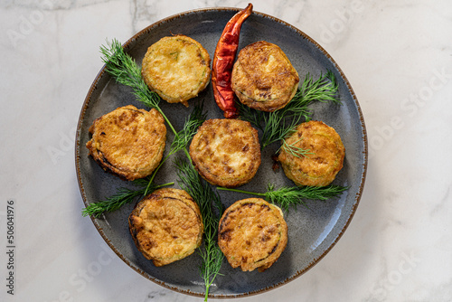 Zucchini with cheese fires with dill and red paper