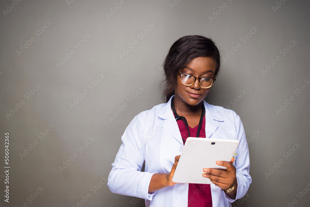 african black female doctor using tablet device checking report african black female doctor using tablet device checking report