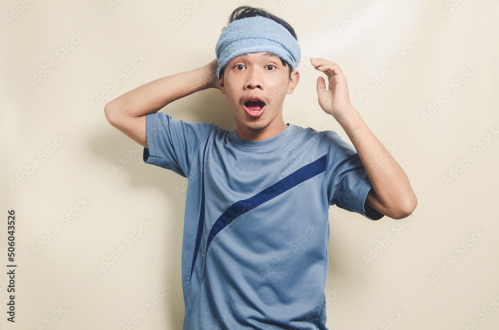Asian young man in sports t-shirt looking happy and expression of victory isolated on background Asian young man in sports t-shirt looking happy and expression of victory isolated on background