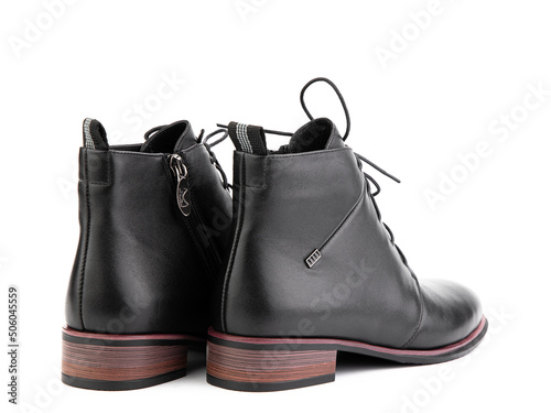 Obraz na płótnie Women's autumn ankle black leather boots with black zip and average brown heels, isolated white background. Back side view. Fashion shoes. w salonie