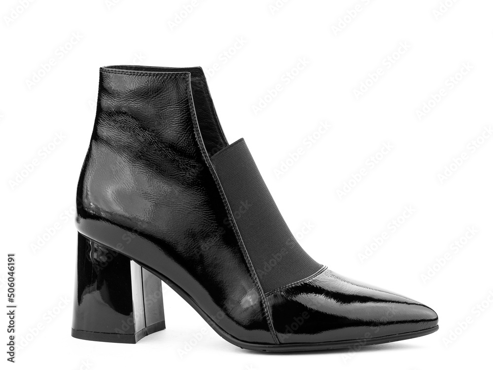 Women's autumn ankle black leather boots with black zip and average heels, isolated white background. Right side view. Fashion shoes.