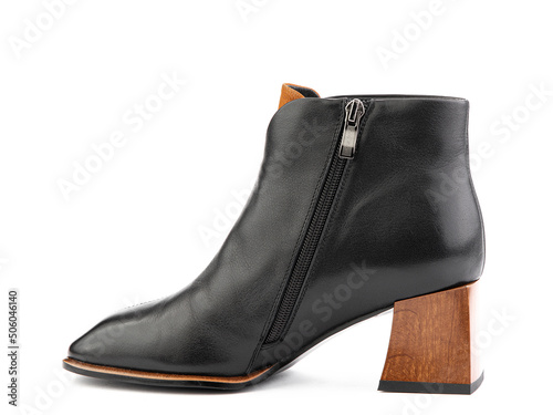 Obraz na płótnie Women's autumn ankle black leather boots with black zip and average brown heels, isolated white background. Left side view. Fashion shoes. w salonie