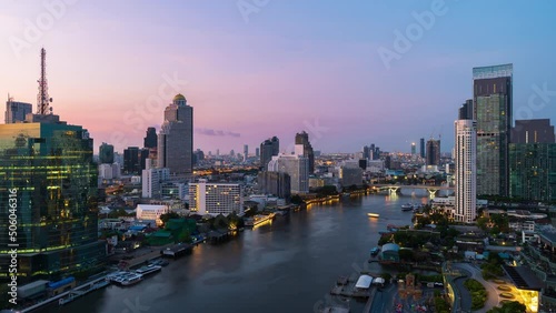 night to day time lapse of Chao Phraya River with King Taksin bridge and building of Bangkok city, Thailand photo
