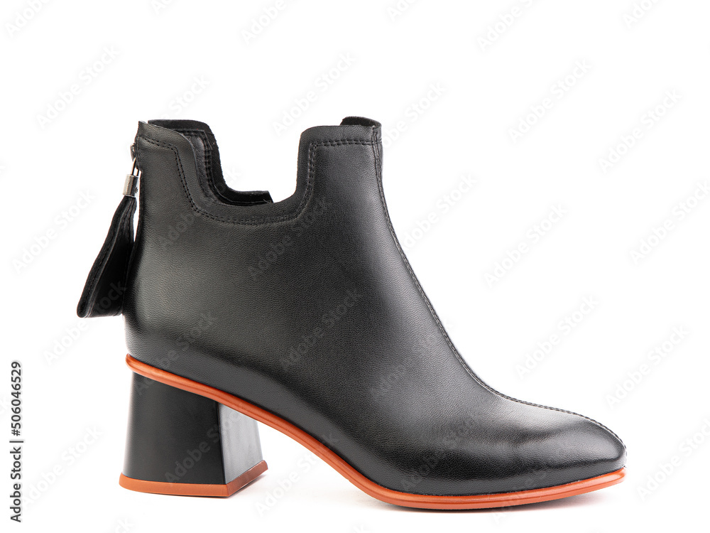 Women's autumn ankle black leather boots with zip and average heels, isolated white background. Right side view. Fashion shoes.