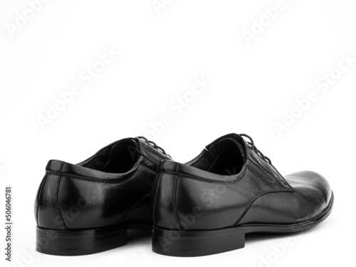 Obraz na płótnie A pair of classic leather elegant men's shoes isolated white background. Groom's stylish black shoes. Isolated object close up on white background. w salonie