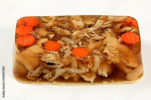 jellied meat pieces on white background. Jelly with meat, pork aspic, traditional russian dish. meat aspic on white photo