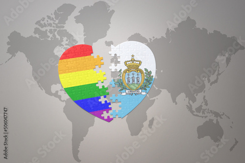 puzzle heart with the rainbow gay flag and san marino on a world map background. Concept.