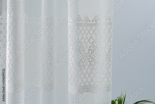 Сlosed up of beautiful grey curtain in cozy room home, interior design concept