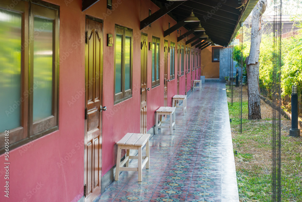 Open terrace with row of windows and doors in asian hotel