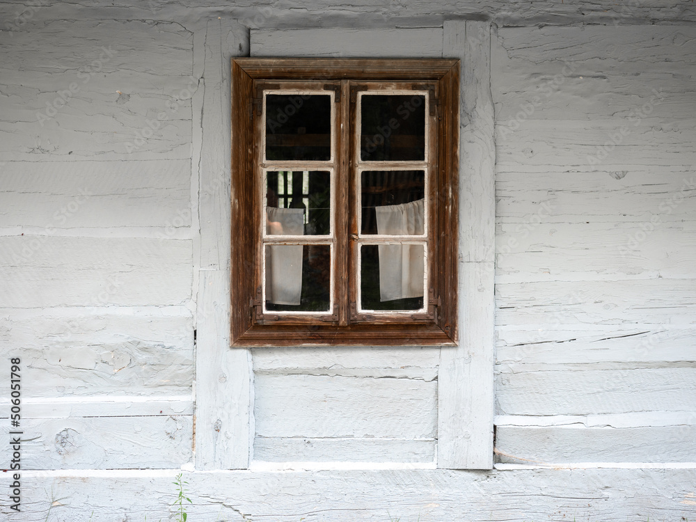 Fototapeta premium A window in a white wooden hut, Traditional wooden hut, Wooden traditional window, Poland