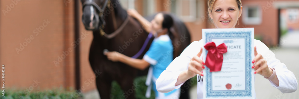 Woman veterinarian showing horse health certificate Stock Photo Adobe Woman veterinarian showing horse health certificate Stock Photo Adobe