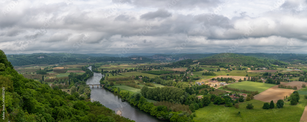 panorama view of the picturesque Dordogne Valley with river and bridge in dense green summer forest