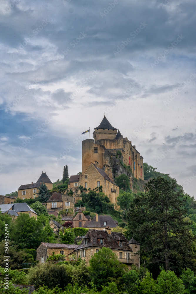 vertical view of the castle in Castelnaud-la-Chapelle in the Dordogne Valley under an overcast sky vertical view of the castle in Castelnaud-la-Chapelle in the Dordogne Valley under an overcast sky
