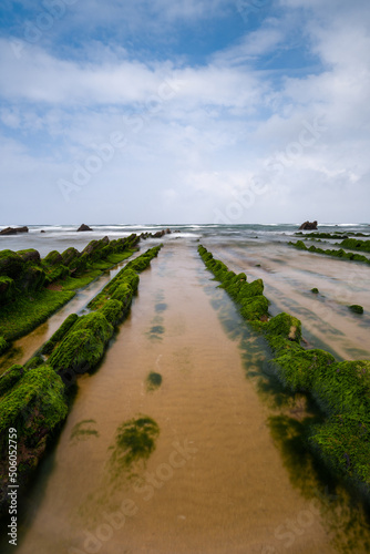 long exposure view of Flysch rock formations at low tide at Barrika beach near Bilbao photo