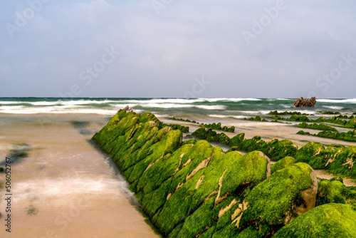 long exposure view of Flysch rock formations at low tide at Barrika beach near Bilbao photo