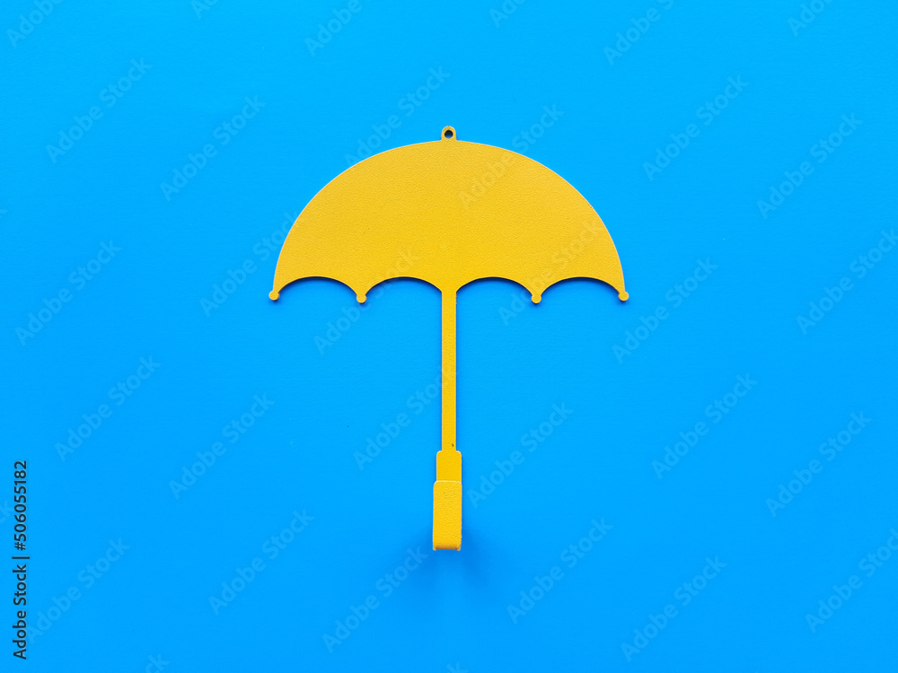 Single Yellow umbrella on a blue background Single Yellow umbrella on a blue background