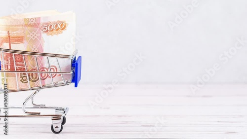 Shopping basket with Russian ruble notes, 5000 rubles in a cart