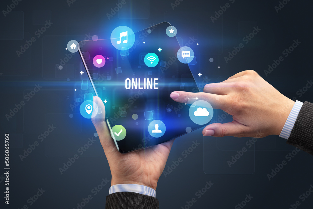 Businessman holding a foldable smartphone Businessman holding a foldable smartphone