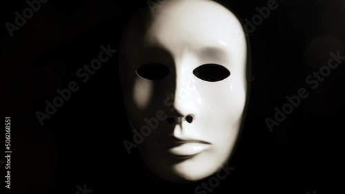 White face mask on dark background. photo