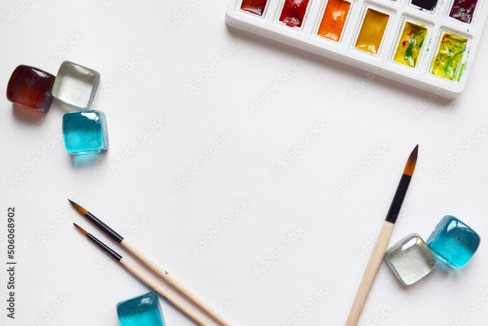 Watercolor paints and brushes, top view. Creative artistic mockup with copyspace. Watercolor paints and brushes, top view. Creative artistic mockup with copyspace.