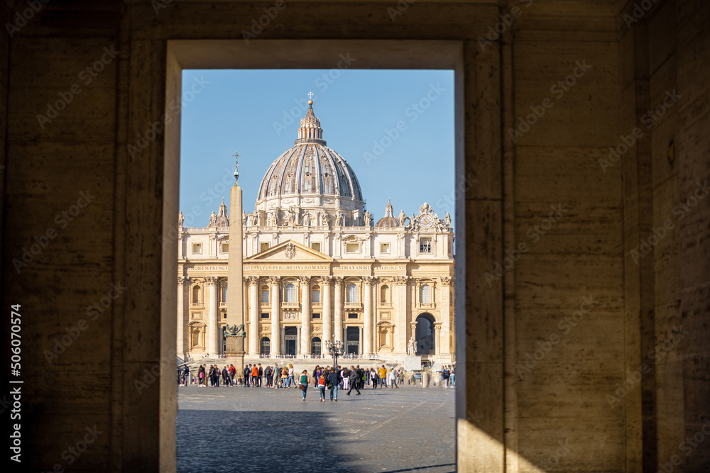 Saint Peter's cathedral in Vatican on sunny day. View through the arch. Concept of religious landmarks and travel Italy