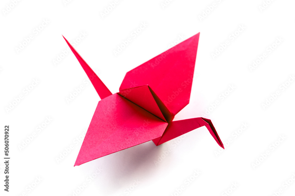 Red paper crane origami isolated on a white background