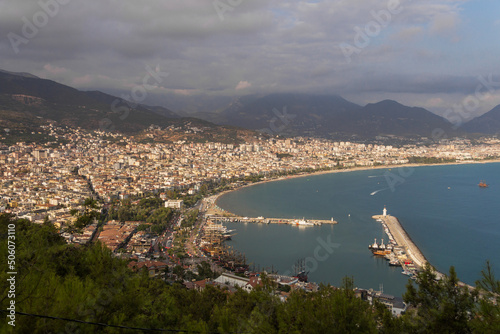 Turkey, Alanya, 30.08.2021: The city of Alanya (Turkey) and the Mediterranean Sea from a bird's eye view. Densely populated city. Travel to Turkey. Sea port