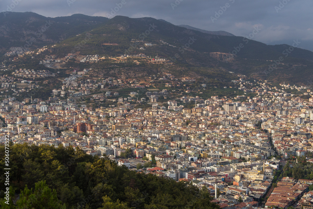 Turkey, Alanya, 30.08.2021: The city of Alanya (Turkey) from a bird's eye view. In the distance you can see an observation deck with the inscription 