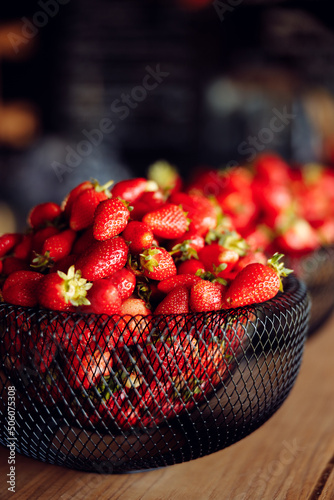 bright tasty juicy strawberries in a black plate