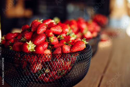 bright tasty juicy strawberries in a black plate