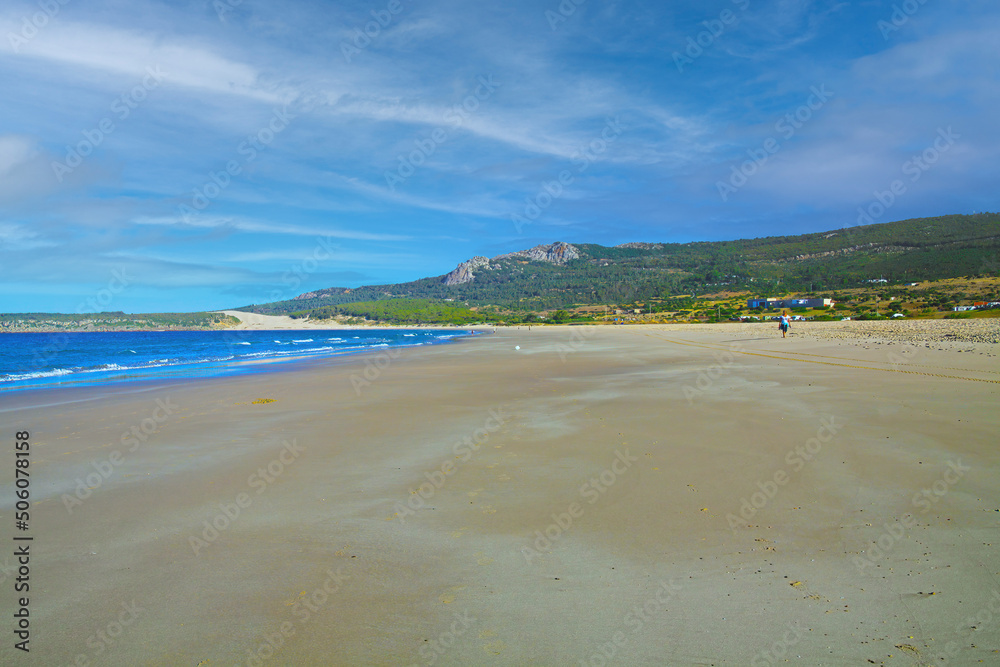 Quiet morning empty beach scene, low tide atlantic sea, green hills - Zahara de los Atunes, Costa de la Luz, Spain
