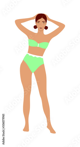 Beautiful young woman in a green mint swimsuit on a white background