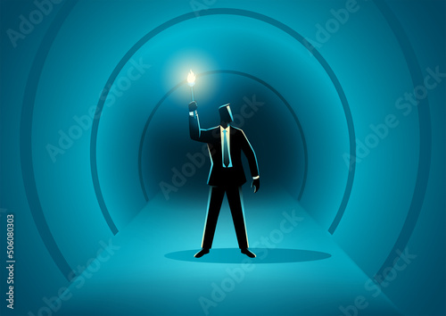 Businessman walking in the dark tunnel holding a torch
