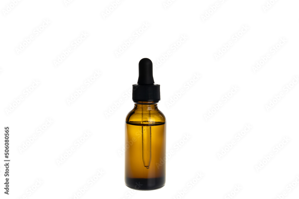 Amber bottle of cosmetic oil with dropper, isolated on white background.