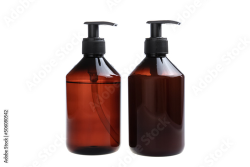 Brown bottles with shampoo and hair conditioner, isolated on white background.