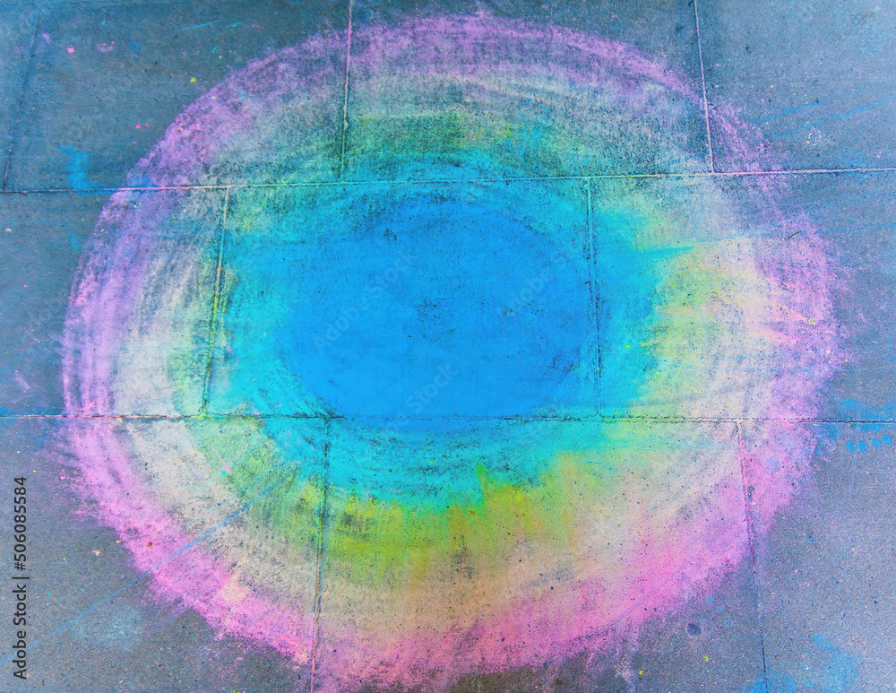 a colorful circle with chalk on a street
