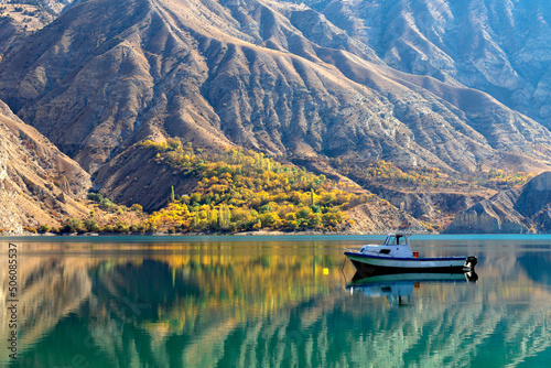 mirror-like lake and boat in autumn