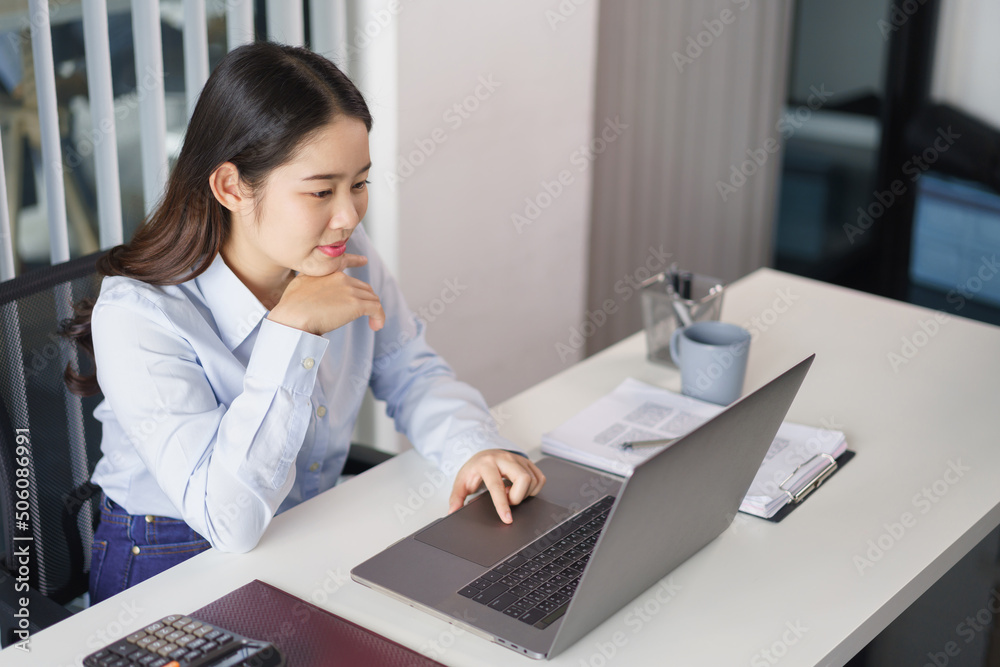 Business concept, Businesswoman thoughtful about new project while reading marketing data on laptop Business concept, Businesswoman thoughtful about new project while reading marketing data on laptop