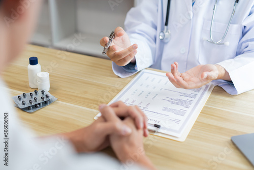 Visiting a doctor concept A physician diagnosing his patient’s symptom and giving description of the patient’s condition.