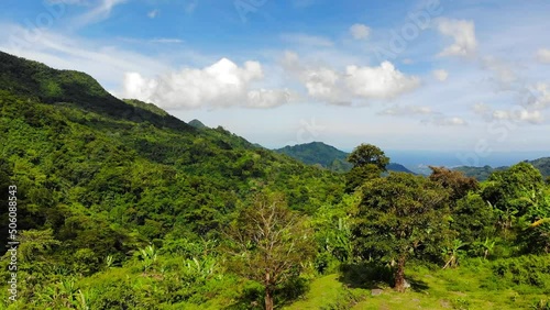 A drone footage from tropical highlands of Philippines, on a bright, sunny day. Shot at the heights of Mount Talinis (Valencia, Negros Oriental, Central Visayas).