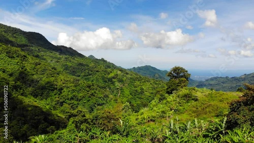 A drone footage from tropical highlands of Philippines, on a bright, sunny day. Shot at the heights of Mount Talinis (Valencia, Negros Oriental, Central Visayas).