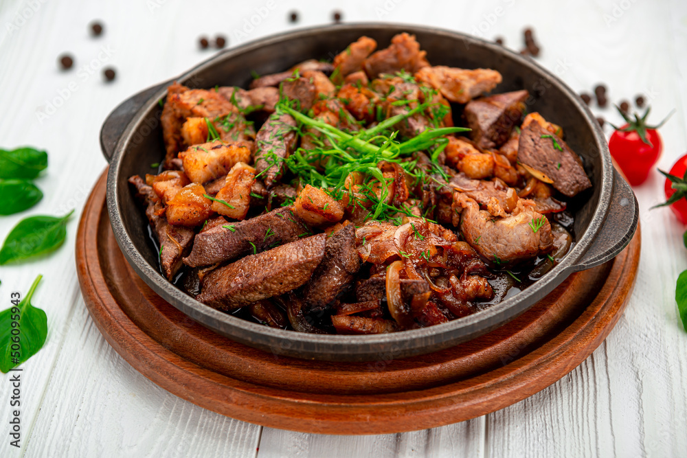 Meat and vegetables in frying pan