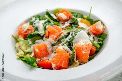 Salad with smoked salmon, fresh vegetables and cream cheese.