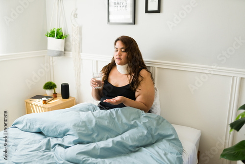 Plus size woman recovering in bed from an injury