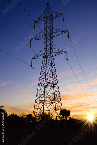 Canvas-taulu silhouette of an electric tower at sunset . Energy concept